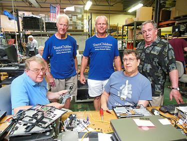 Gordie and Mark Howe with TeamChildren founder and volunteers