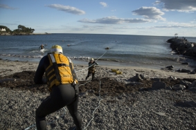Firefighters practicing line hauling during ocean rescue training