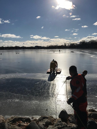 Firefighters using an ice rescue sled to perform a rescue