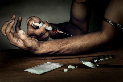 A Junkie with A Syringe and Opioid Drugs